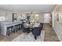 Elegant dining area with a glass-top table and dark velvet chairs at 201 School St, High Shoals, NC 28077