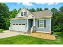 Charming home with blue siding, a two-car garage, and well-maintained landscaping at 25622 Seagull Dr # 645, Lancaster, SC 29720