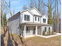 Gray siding two story house with stone accents and a side view of the home at 8001 Willhill Rd, Charlotte, NC 28227