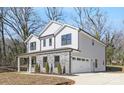 Two-story house with gray siding, stone accents, and a two-car garage at 8001 Willhill Rd, Charlotte, NC 28227