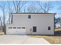 Two-car garage with white doors and a concrete driveway at 8001 Willhill Rd, Charlotte, NC 28227