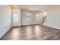 Bright living room with hardwood floors and a staircase at 9744 Inkberry Dr, Gastonia, NC 28056