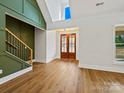 Bright living space with hardwood floors, vaulted ceiling, and natural light from large windows at 4539 Polk Ford Rd, Stanfield, NC 28163