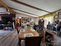 Combined dining and living area with wood floors and exposed beams at 325 Scaley Bark Dr, Salisbury, NC 28147