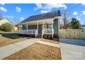 Newly built home with a welcoming front porch and landscaped yard at 102 S Liberty St, Gastonia, NC 28052