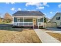 Newly built home with a welcoming front porch and landscaped yard at 102 S Liberty St, Gastonia, NC 28052