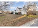 Two-story house with attached garage, side yard view at 13039 Peacock Ln, Charlotte, NC 28215