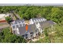 Stunning aerial view of townhome community surrounded by lush greenery, with city skyline in distance at 1421 Collier Walk Aly # Csw0209, Charlotte, NC 28205