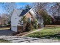 A home's exterior shows a brick accent, side entry garage, and a well-manicured lawn with greenery at 117 Eagle Ct, Mooresville, NC 28117