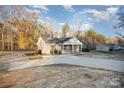 Attractive home with a concrete driveway and well-manicured grounds, surrounded by lush trees at 1681 Evans Dr, Lancaster, SC 29720