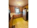 Galley kitchen with wood cabinets and yellow flooring at 1895 Forest Lake Dr, Rock Hill, SC 29732