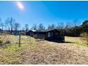 Dark wood siding home with a fenced yard at 5199 Helms End Of Trl, Lincolnton, NC 28092