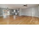 Open concept living room and kitchen with hardwood floors at 1176 Peppertree Dr, Mount Holly, NC 28120