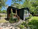 Charming home with a welcoming porch and landscaped front yard featuring rocks and healthy shrubbery at 3452 Airlie St, Charlotte, NC 28205