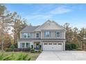 Charming two-story home featuring a well-maintained front yard, attached two-car garage, and classic architectural details at 6003 Hawk View Rd, Waxhaw, NC 28173