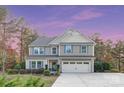 Charming two-story home featuring a well-maintained front yard, attached two-car garage, and classic architectural details at 6003 Hawk View Rd, Waxhaw, NC 28173