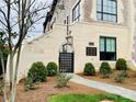 Charming entrance with stone path, gated entry, and lush landscaping at 1168 Queens Rd, Charlotte, NC 28207