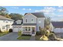 Two-story house with gray siding, front porch, and attached garage at 440 Luray Way, Rock Hill, SC 29730