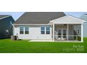The house features a screened porch, two windows, green lawn, and air conditioner unit at 885 Exeter Dr, Sherrills Ford, NC 28673