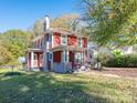 Charming two-story home with a covered front porch and mature landscaping at 1411 Lineberger Ave, Gastonia, NC 28052
