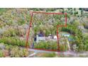 Aerial view of a property with a red outline showing the boundaries surrounded by lush trees at 2164 Mission Rd, York, SC 29745