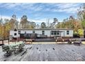Large backyard deck for outdoor entertaining, featuring ample seating and views of mature trees at 2164 Mission Rd, York, SC 29745