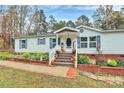 Charming single-story home with well-manicured landscaping and a welcoming front porch decorated for fall at 2164 Mission Rd, York, SC 29745