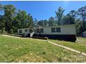 Inviting single-story home with a lush front yard and quaint walkway, perfect for outdoor enjoyment at 2164 Mission Rd, York, SC 29745