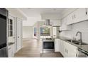 Modern kitchen featuring stainless steel appliances and a view into the living area at 9001 Vicksburg Rd, Charlotte, NC 28227