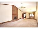 Spacious living room with a brick fireplace, carpeted floor, and natural light at 206 Swaim Ct, Salisbury, NC 28147