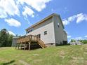 Exterior view of home's backyard featuring a wooden deck, stairs, and lawn at 2387 Trundle Dr # Cwo0155, Gastonia, NC 28054