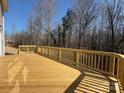 Large wood deck perfect for entertaining with wooden railing and a view of the wooded area at 2387 Trundle Dr # Cwo0155, Gastonia, NC 28054