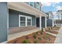 Townhouse exterior with front porch and landscaping at 115 Ciara Pl # D, Mooresville, NC 28117