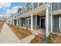 Townhouse exterior with front porch and landscaping at 115 Ciara Pl # D, Mooresville, NC 28117