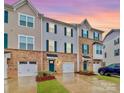 Three-story townhome with two-car garage and landscaped front yard at 2608 Grantham Place Dr, Fort Mill, SC 29715