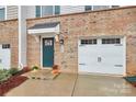 Townhome's front entrance with teal door and attached garage at 2608 Grantham Place Dr, Fort Mill, SC 29715