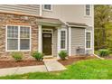 Inviting front entry with stone accents and a charming dark brown door at 786 Petersburg Dr, Fort Mill, SC 29708