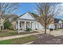 Charming single story home featuring a covered porch and well-maintained landscaping at 9311 Glenashley Dr, Cornelius, NC 28031