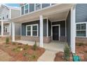 Covered porch with brick base and white columns at 115 Ciara Pl # A, Mooresville, NC 28117