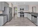 Modern kitchen featuring stainless steel appliances, gray cabinets and granite countertops at 18023 Train Station Dr, Cornelius, NC 28031