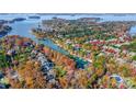 Stunning aerial view of a waterfront community showcasing fall foliage and lake access at 20361 Enclave Oaks Ct, Cornelius, NC 28031