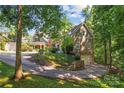 Gorgeous home with stone detailing, a curved driveway, and beautifully landscaped surroundings at 20361 Enclave Oaks Ct, Cornelius, NC 28031