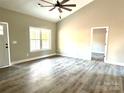 Bright living room with vaulted ceiling, wood-look floors, and ceiling fan at 1162 Scenic Cir, Shelby, NC 28150