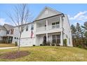 Two story home featuring a welcoming front porch and lush green lawn at 122 W Heart Pine Ln, Statesville, NC 28677