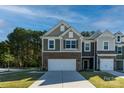 Two-story townhome with brick and siding, two-car garage, and landscaped lawn at 278 Harpers Run Ln, Matthews, NC 28104