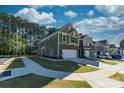 Two-story townhome with green siding, brick accents, and a two-car garage at 278 Harpers Run Ln, Matthews, NC 28104