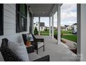 Relaxing front porch with wicker chairs and view of neighborhood at 1325 Ballard Dr, Waxhaw, NC 28173