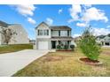 Two-story house with gray siding, white garage door, and landscaping at 1964 Clear Brooke Dr, Kannapolis, NC 28083