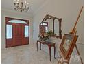 Elegant entryway with marble flooring, a chandelier, and a large mirror at 206 N Trexler Ave, Rockwell, NC 28138