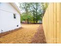 Large backyard with wood fence and pine straw ground cover at 6372 Morehead Rd, Harrisburg, NC 28075